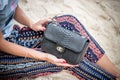 Close up of luxury handmade snakeskin python handbag in woman hands. Tropical Bali island. Royalty Free Stock Photo