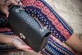 Close up of luxury handmade snakeskin python handbag in woman hands. Tropical Bali island. Royalty Free Stock Photo