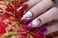 Close up luxury sparkling red color gel polish painting 3D rose flower decorate d with shiny rhinestone and glitter on fashionista