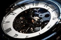 Close-Up of Luxury vintage mechanical watch with visible mechanism., In dark tone. Royalty Free Stock Photo