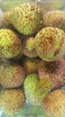 close up lychee fruits in a cold water background