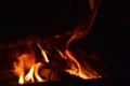 Close up, macro. Burning wood in the fireplace. Flame in the darkness