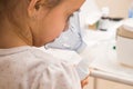 Close up, macro. Clinic, treatment. A 5-year-old child inhales medication using a nebulizer. Therapy of coronavirus Royalty Free Stock Photo