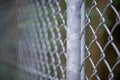 Macro focus on steel pole of chain link fence