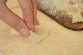 Close up macro detail of process of homemade vegan farfalle pasta with durum wheat flour. The cook kneads the dough on the wooden Royalty Free Stock Photo