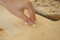 Close up macro detail of process of homemade vegan farfalle pasta with durum wheat flour. The cook kneads the dough on the wooden Royalty Free Stock Photo