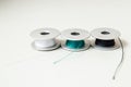 Close up, macro. Details. Sewing spools with black, blue and white threads. Copy space Royalty Free Stock Photo