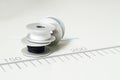 Close up, macro. Details. Sewing spools with black, blue and white threads Royalty Free Stock Photo