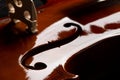 Close up macro of F hole on brown wooden fiddle or violin, classic musical instrument, on black background