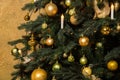 Close up, macro. Festive christmas background. Decorated Christmas tree, strewn with golden balls and lights of candles