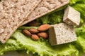 Close up. Flat lay. Diet food. Vegan snack. Green lettuce, almond, tofu, bread without yeast