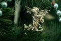 Close up, macro. A fragment of a Christmas tree, silver angel decoration