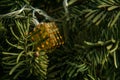 Close up, macro. A fragment of a New Year`s garland of luminous golden cubes on a New Year`s pine