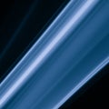 A close up macro photo of a diagonal wisp of smoke lit with blue flash gel on a black background that makes an abstract artistic Royalty Free Stock Photo