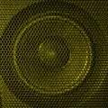 A close up macro photo of a speaker lit with a vibrant golden flash gel