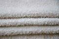 Close-up macro photo of a stack of many small white towels