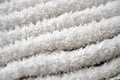 Close-up macro photo of a stack of many small white towels