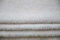 Close-up macro photo of a stack of many small white towels