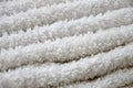 Close-up macro photo of a stack of many small white towels