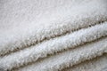 Close-up macro photo of a stack of many small white towels