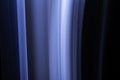 A close up macro photo of a vertical wisp of blue smoke on a black background that makes an abstract artistic retro background Royalty Free Stock Photo