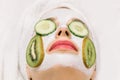 Close up macro photo of young woman with facial homemade mask from natural ingredients to hydrate skin, fresh cucumber Royalty Free Stock Photo