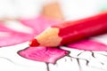 A close up macro portrait of a red pencil lying on a coloring book for adults. The page is already a bit colored in, but some Royalty Free Stock Photo