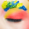 Close-up macro shot of closed teenager female eye with unusual art make-up and face painting on brows and around eye Royalty Free Stock Photo