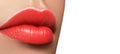 Close-up macro shot of female mouth. Glamour red lips Makeup with sensuality gesture. Juicy gloss lipstick