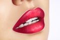 Close-up macro shot of female mouth. Glamour red lips Makeup with sensuality gesture. Magenta gloss lipstick