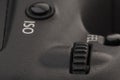 Close-up macro shot of a modern digital SLR camera. Detailed photo of black camera body with a classic wide aperture portrait lens Royalty Free Stock Photo