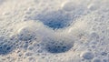 Close up macro shot of numerous small and large white soap bubbles and foam forming a textured surface with light Royalty Free Stock Photo
