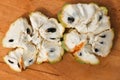 Close up macro shot of an opened up Sugar apple. Fruta de Conde Earl Fruit on a wooden surface with clearly visible Royalty Free Stock Photo