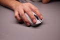 Close-up Macro Shot: Person& x27;s Hand Using Wireless Computer Mouse, Scrolls through Apps and Websites with a Wheel and Clicks Royalty Free Stock Photo