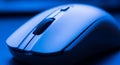 Close Up Macro Shot of a Wireless Computer Mouse in Blue Light technology device Royalty Free Stock Photo