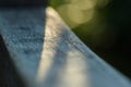 Close up Macro shot of a wooden log - a pole at sunset A small cone of light shining on wood