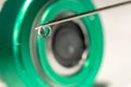 Close-up or macro of syringe needle with a drop at the tip, cap of a vial bottle in the background Royalty Free Stock Photo