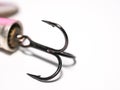 Close up / macro of a treble fishing hook attached to a lure.