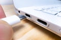 Close-up macro view of plugging USB type C cable into computer port