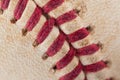 Close up macro view of red stitched seams of an worn baseball Royalty Free Stock Photo