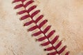 Close up macro view of red stitched seams of an worn baseball