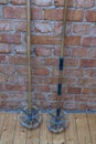 Close up macro view of very old vintage ski poles isolated on brick wall background. Royalty Free Stock Photo