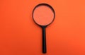 Close up Magnifying glass  on a orange background Royalty Free Stock Photo