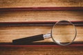 Close-up of magnifying glass on edge books Royalty Free Stock Photo