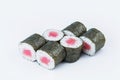 Close-up of Maguro Maki Roll with raw tuna fillet and rice wrapped in nori seaweed isolated on gray background