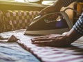 Close up maid ironing clothes in hotel cozy room Royalty Free Stock Photo