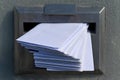 Mailbox full of letters in a letterbox Royalty Free Stock Photo