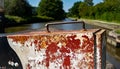 Close-Up Of Old Rusty Metal Railing Against canal waterway Royalty Free Stock Photo