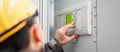 Close up of maintenance engineer testing voltage switchgear