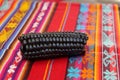 Close up of Maiz Morado, Purple Corn, Zea mays indurata, k\'culli or Black Aztec Corn on a traditional colourful red peruvian